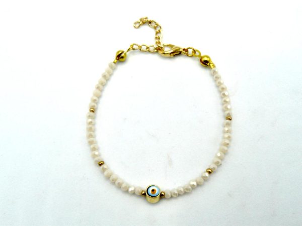 Gold-Plated Brass Bracelet With White Beads and Lobster Clasp Adjustable Closure. The Central Bead Has an Eye-Like Pattern and is Encased in a Layer of Gold-Plated Brass